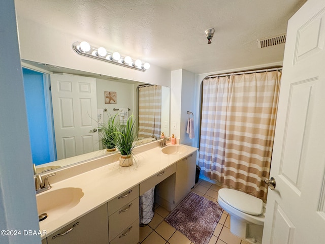 bathroom featuring toilet, tile patterned floors, a textured ceiling, a shower with curtain, and vanity