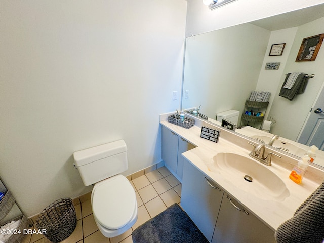 bathroom featuring toilet, vanity, and tile patterned floors