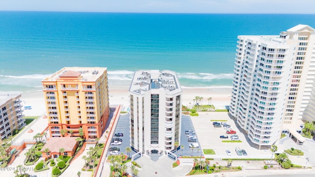 aerial view with a water view and a beach view