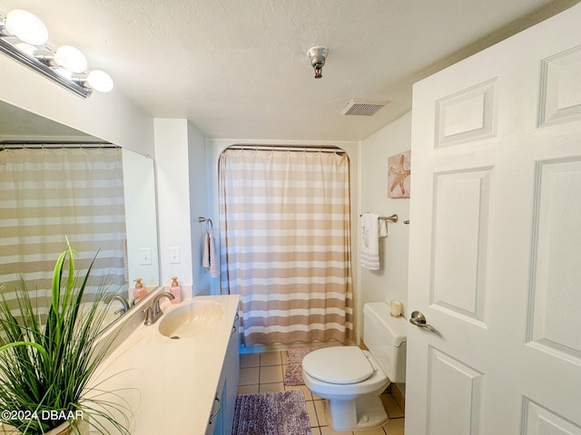 bathroom featuring vanity, tile patterned flooring, a textured ceiling, and toilet