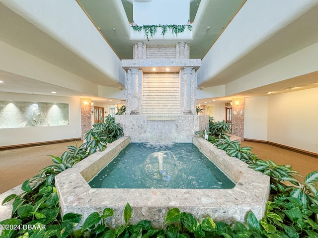 view of pool featuring a hot tub and pool water feature