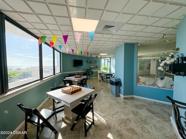 dining space with a drop ceiling