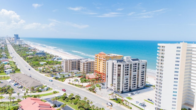 birds eye view of property featuring a water view and a beach view