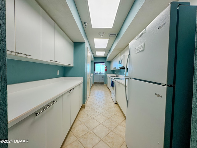 kitchen featuring white cabinetry, white appliances, and light tile patterned floors