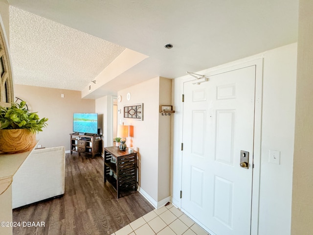 entrance foyer with hardwood / wood-style flooring and a textured ceiling