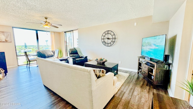 living room featuring expansive windows, ceiling fan, a textured ceiling, and dark hardwood / wood-style flooring