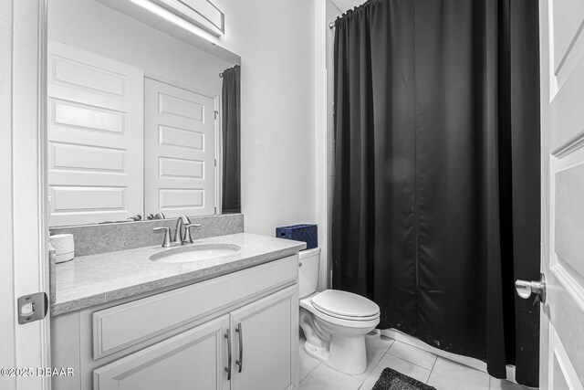 full bathroom featuring toilet, curtained shower, vanity, and tile patterned floors