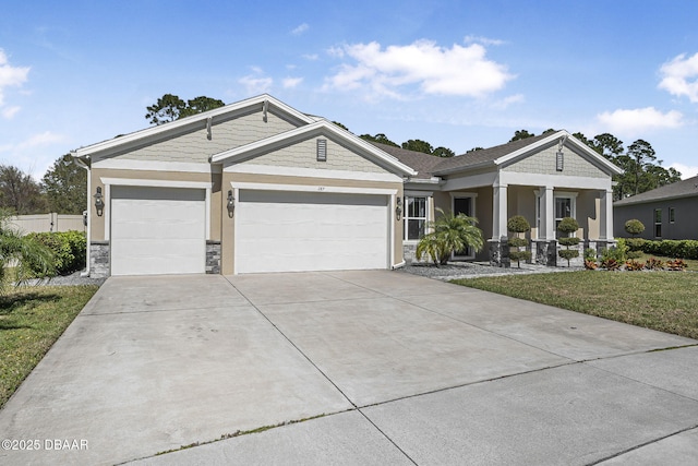 view of front of house featuring a garage, a front lawn, concrete driveway, and stucco siding