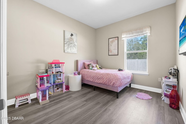 bedroom with baseboards and wood finished floors