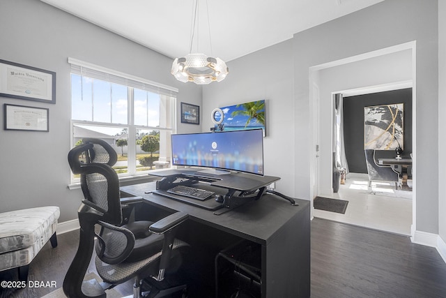 office area with an inviting chandelier, baseboards, and wood finished floors