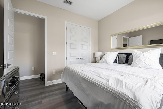 bedroom featuring baseboards, visible vents, and dark wood-type flooring