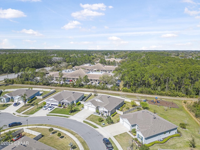 bird's eye view featuring a forest view and a residential view