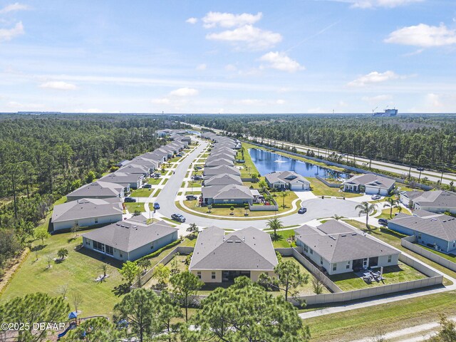 bird's eye view with a residential view, a water view, and a wooded view