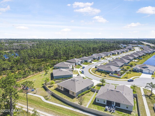 aerial view featuring a forest view and a residential view