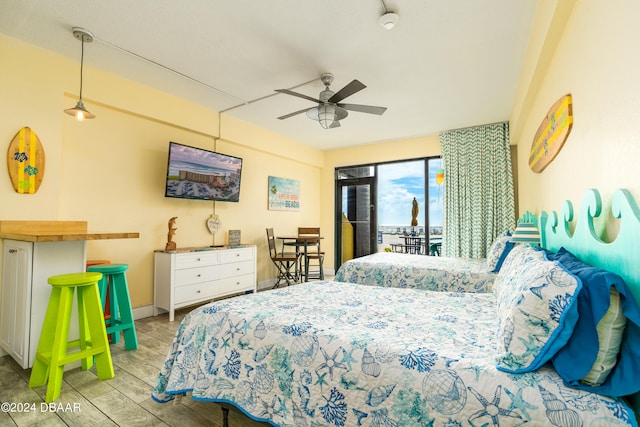 bedroom featuring access to outside, ceiling fan, and light hardwood / wood-style flooring