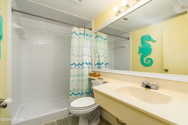 bathroom with hardwood / wood-style floors, vanity, toilet, and a shower with curtain