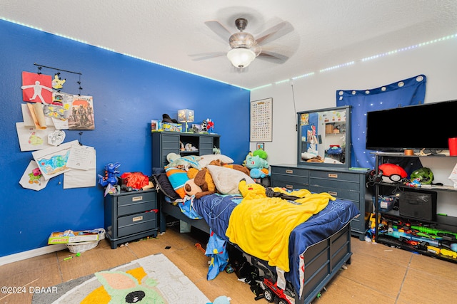 bedroom featuring a textured ceiling and ceiling fan