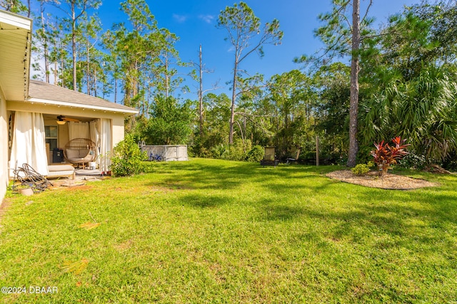 view of yard with ceiling fan