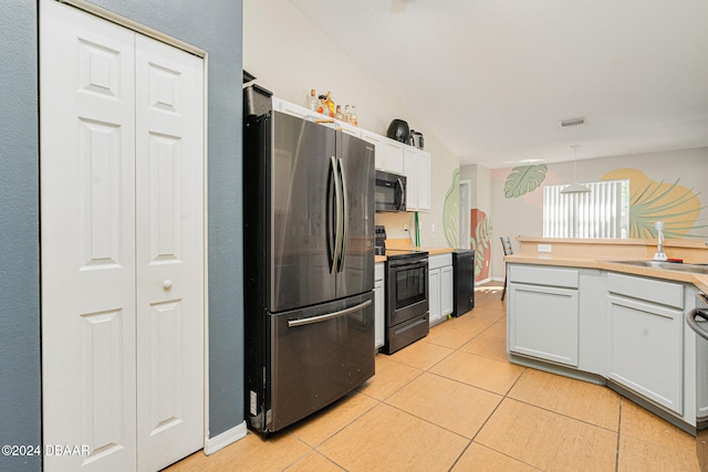 kitchen with white cabinetry, sink, light tile patterned floors, and stainless steel appliances