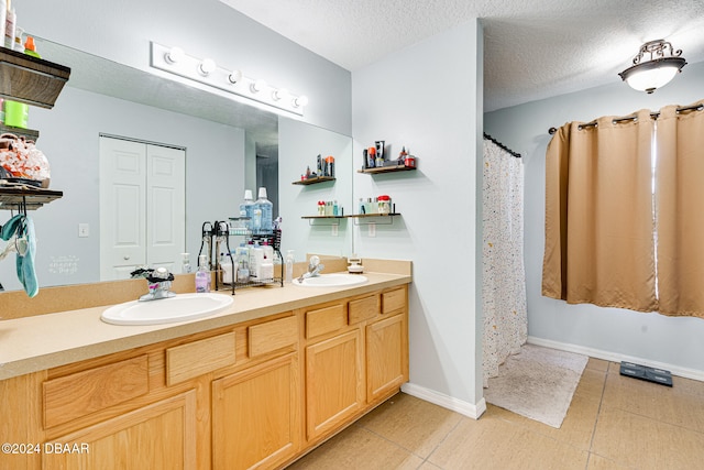 bathroom with vanity, a textured ceiling, tile patterned floors, and a shower with curtain