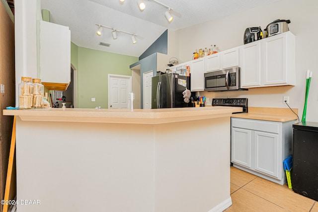 kitchen with kitchen peninsula, light tile patterned floors, rail lighting, white cabinetry, and appliances with stainless steel finishes