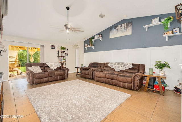 tiled living room with ceiling fan and vaulted ceiling