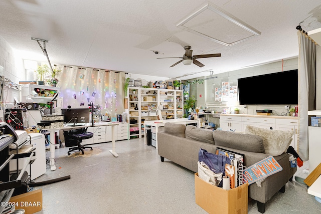 living room featuring a textured ceiling and ceiling fan