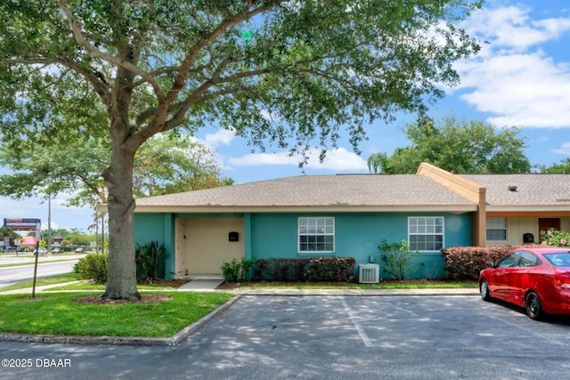 ranch-style home with central AC unit