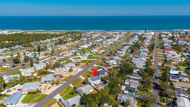 drone / aerial view with a water view and a residential view