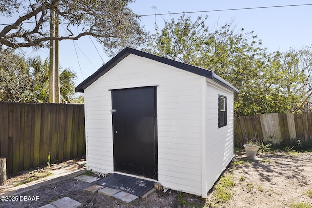 view of shed with a fenced backyard