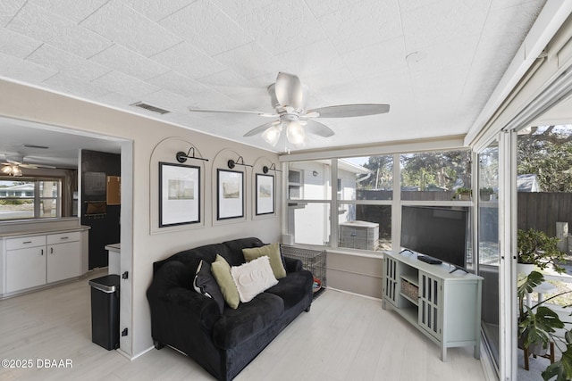 interior space featuring plenty of natural light, visible vents, and a ceiling fan