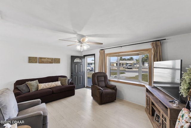 living room with light wood-type flooring and ceiling fan