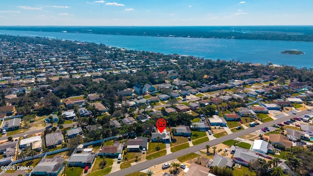 drone / aerial view featuring a water view and a residential view