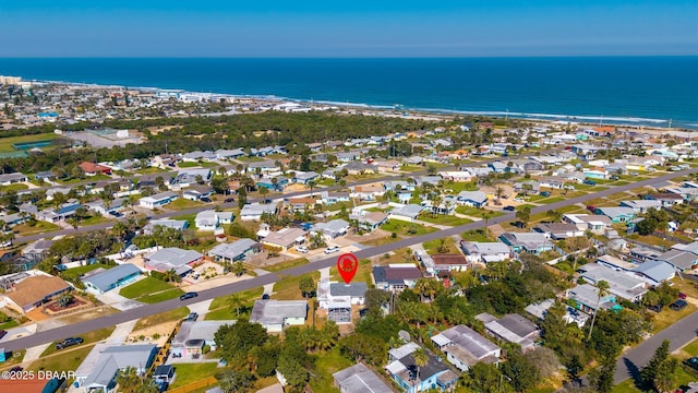 drone / aerial view with a water view and a residential view