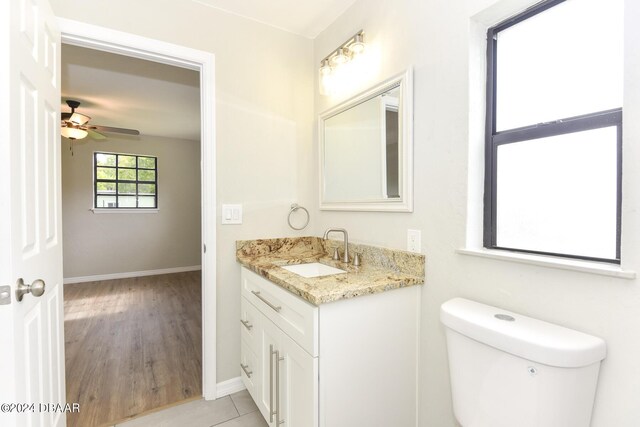 732 Orchard Ave, Ormond Beach, FL 32174 - half bathroom with baseboards, vanity, a ceiling fan, and toilet