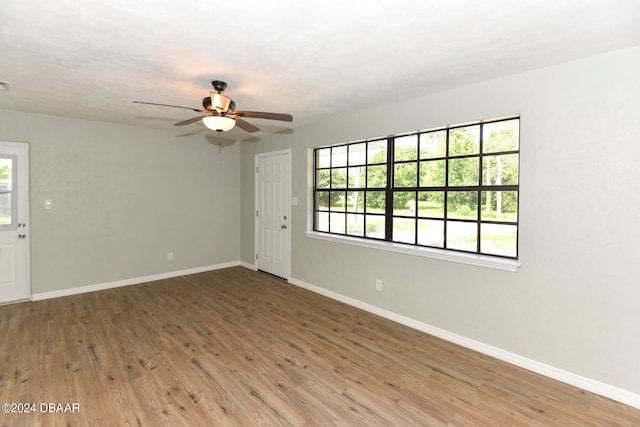 empty room with wood-type flooring and ceiling fan