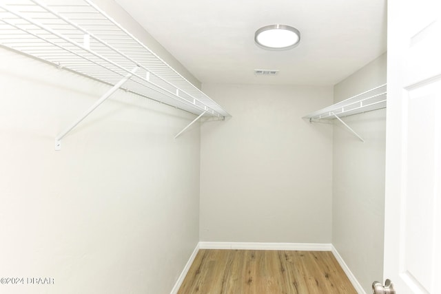 spacious closet featuring hardwood / wood-style floors