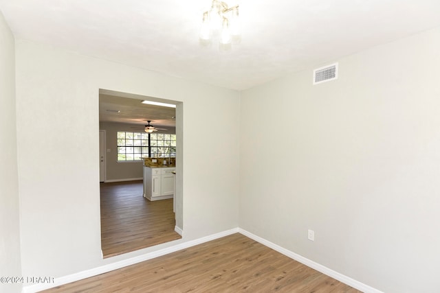 empty room featuring wood-type flooring and ceiling fan