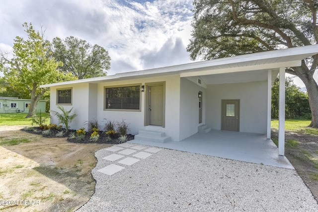 732 Orchard Ave, Ormond Beach, FL 32174 - single story home with entry steps, stucco siding, and a carport