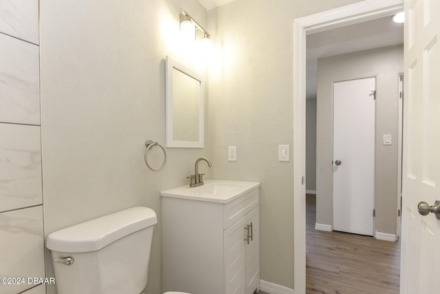 732 Orchard Ave, Ormond Beach, FL 32174 - bathroom with wood finished floors, toilet, vanity, and baseboards