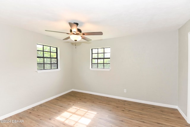 unfurnished room featuring light hardwood / wood-style floors, ceiling fan, and a healthy amount of sunlight