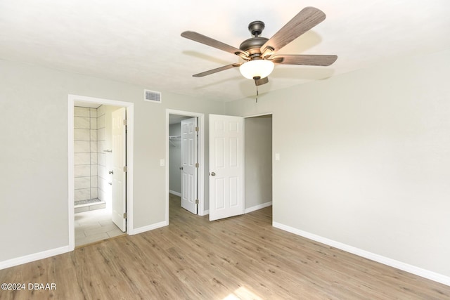 732 Orchard Ave, Ormond Beach, FL 32174 - unfurnished bedroom featuring light wood finished floors, baseboards, a closet, and connected bathroom