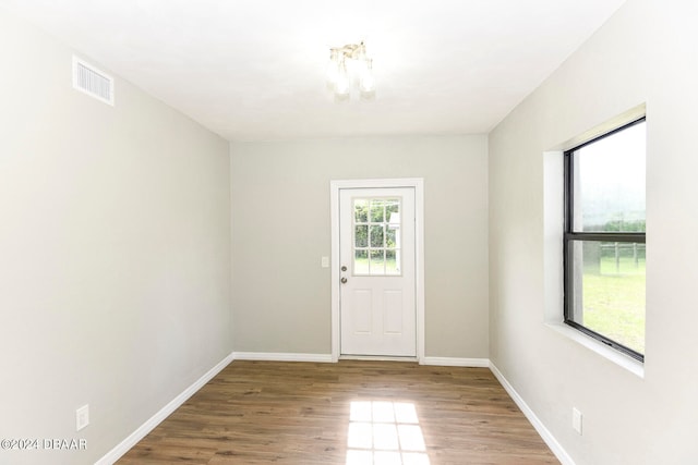 unfurnished room with wood-type flooring