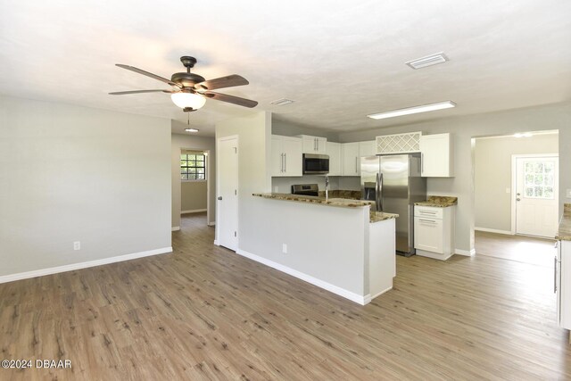 732 Orchard Ave, Ormond Beach, FL 32174 - kitchen with appliances with stainless steel finishes, ceiling fan, white cabinets, and baseboards