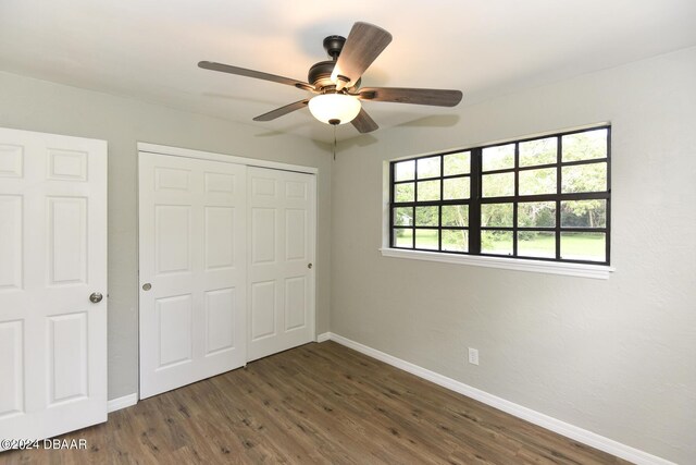 732 Orchard Ave, Ormond Beach, FL 32174 - unfurnished bedroom featuring dark wood-type flooring, a closet, baseboards, and ceiling fan