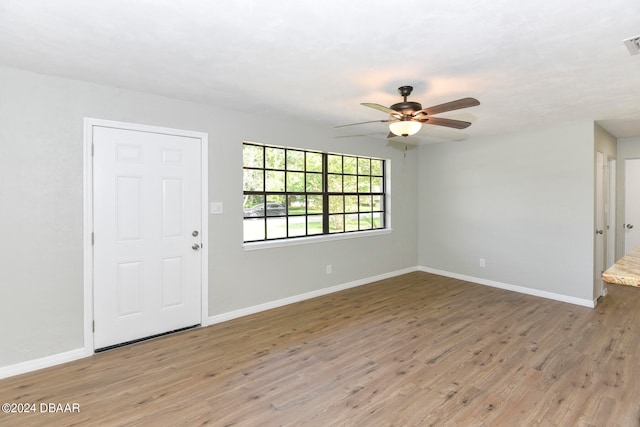 foyer entrance with hardwood / wood-style floors and ceiling fan