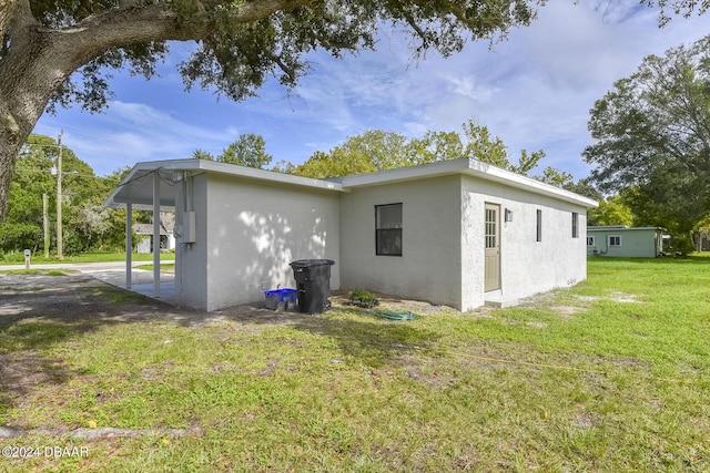 732 Orchard Ave, Ormond Beach, FL 32174 - view of side of home with stucco siding and a lawn