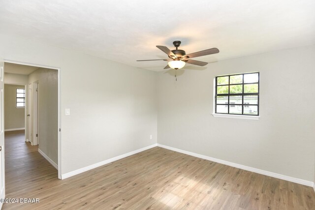 732 Orchard Ave, Ormond Beach, FL 32174 - empty room with a ceiling fan, baseboards, healthy amount of natural light, and light wood finished floors