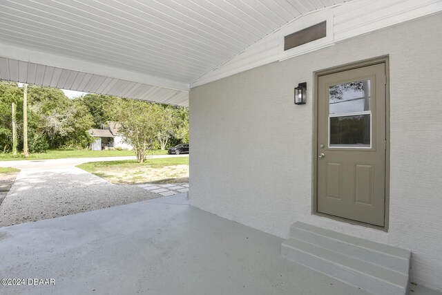 732 Orchard Ave, Ormond Beach, FL 32174 - view of exterior entry with a patio and stucco siding