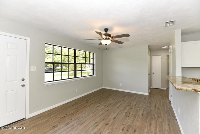 732 Orchard Ave, Ormond Beach, FL 32174 - unfurnished living room featuring baseboards, light wood-style floors, and ceiling fan